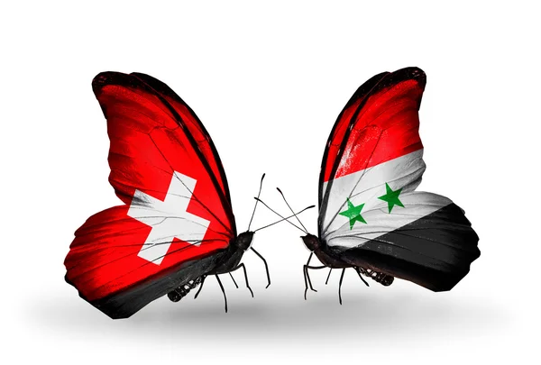 To sommerfugle med flag på vinger som symbol på forbindelserne Schweiz og Syrien - Stock-foto