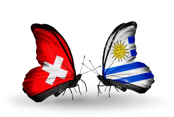 Two butterflies with flags on wings as symbol of relations Switzerland and Uruguay — Stock Photo, Image