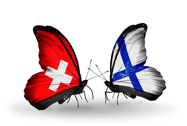 Two butterflies with flags on wings as symbol of relations Switzerland and Finland — Stock Photo, Image