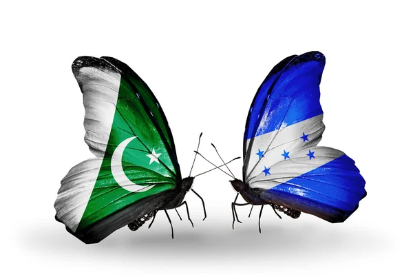 Deux papillons avec des drapeaux du Pakistan et du Honduras sur les ailes — Photo