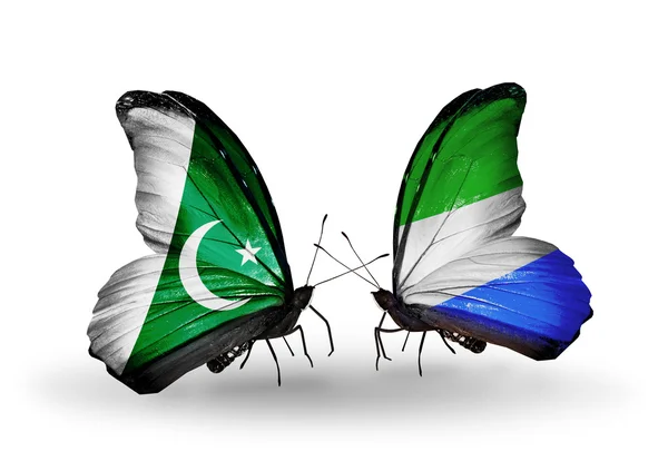 Deux papillons avec des drapeaux du Pakistan et de la Sierra Leone sur les ailes — Photo