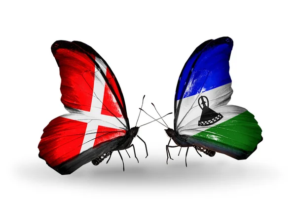 Dwa motyle z flagami Danii oraz lesotho na skrzydłach — Zdjęcie stockowe