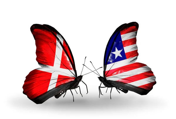 Dwa motyle z flagami dania i Liberii na skrzydłach — Zdjęcie stockowe