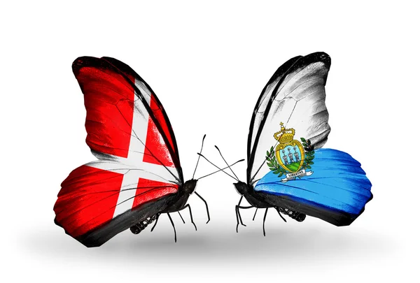 Two butterflies with flags of Denmark and San Marino on wings — Stock Photo, Image