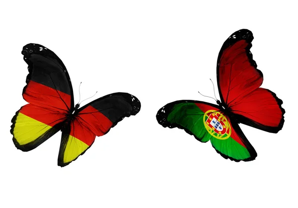 Two butterflies with German and Portuguese flags flyin — Stock Photo, Image