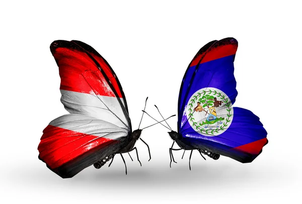 Deux papillons avec des drapeaux de l'Autriche et du Belize sur les ailes — Photo
