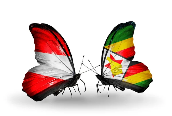 Dva motýli s vlajkou Rakouska a zimbabwe na křídlech — Stock fotografie