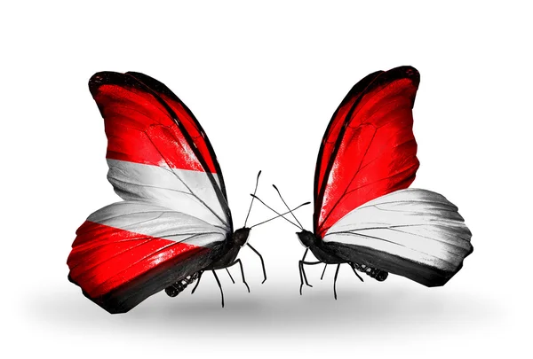 Dva motýli s vlajkami Rakouska a Monaku, Indonésie na křídlech — Stock fotografie