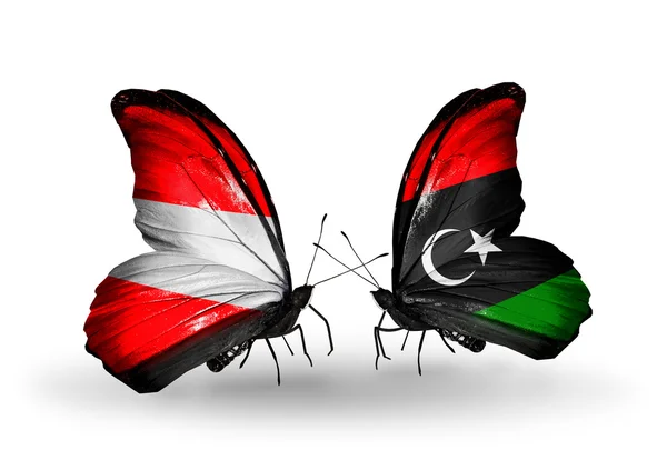 Dwa motyle z flagami Austrii i Libii na skrzydłach — Zdjęcie stockowe