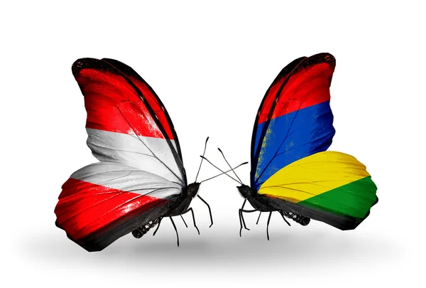 Dwa motyle z flagami Austrii i mauritius na skrzydłach — Zdjęcie stockowe
