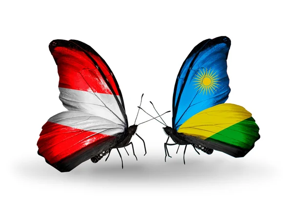 Twee vlinders met vlaggen van Oostenrijk en rwanda op vleugels — Stockfoto