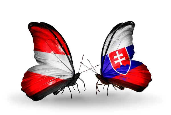 Dwa motyle z flagami Austrii i Słowacji na skrzydłach — Zdjęcie stockowe