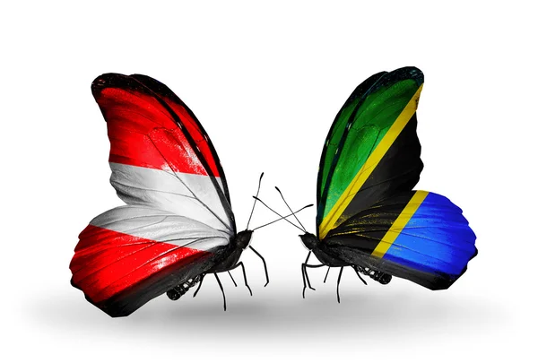 Две бабочки с флагами Австрии и Танзании на крыльях — стоковое фото