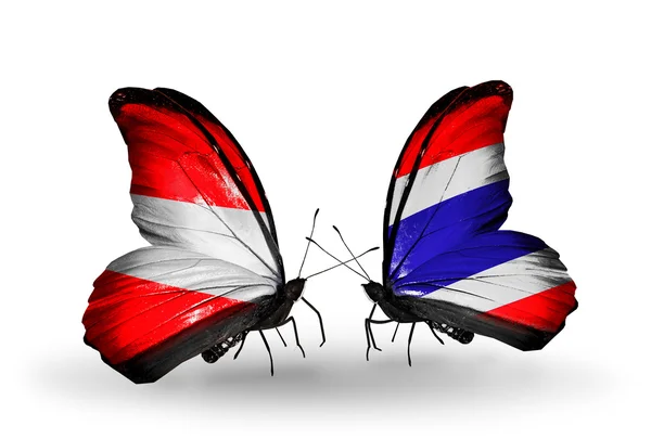 Twee vlinders met vlaggen van Oostenrijk en thailand op vleugels — Stockfoto