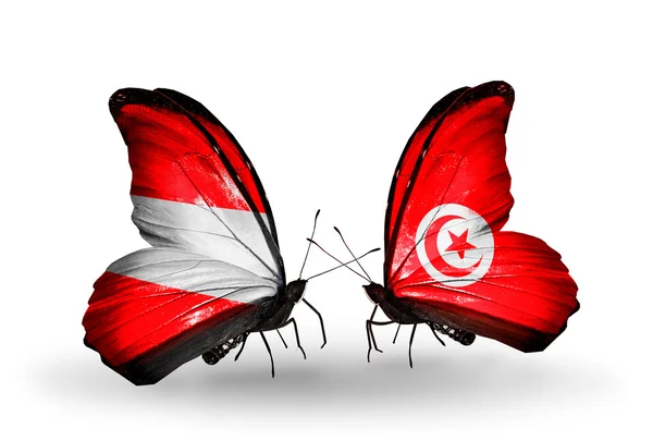 Dva motýli s vlajkami Rakouska a Tunisko na křídlech — Stock fotografie