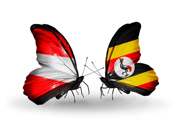 Twee vlinders met vlaggen van Oostenrijk en Oeganda op vleugels — Stockfoto