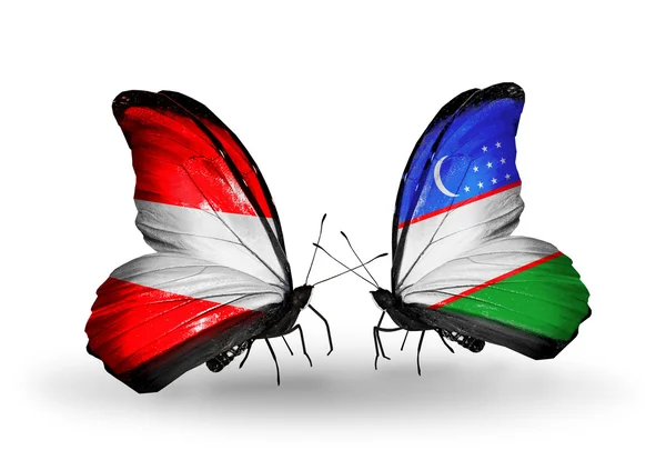 Deux papillons avec des drapeaux d'Autriche et d'Ouzbékistan sur les ailes — Photo