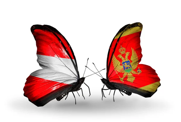 Dos mariposas con banderas de Austria y Montenegro en alas — Foto de Stock