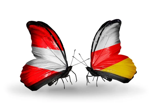 Two butterflies with flags of Austria and South Ossetia on wings — Stock Photo, Image