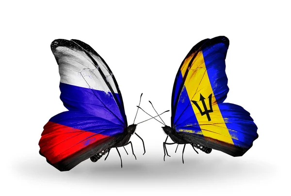 Dos mariposas con banderas de Rusia y Barbados en alas — Foto de Stock