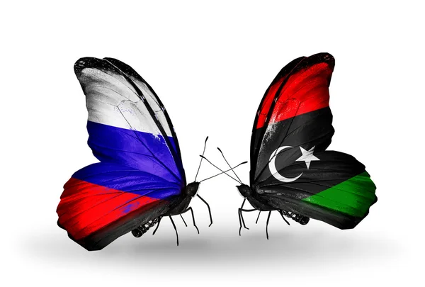 Dva motýli s vlajkami Ruska a Libye na křídlech — Stock fotografie