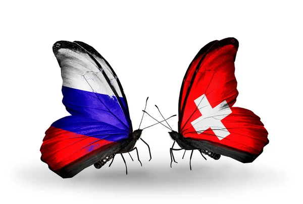 Two butterflies with flags of Russia and Switzerland on wings — Stock Photo, Image