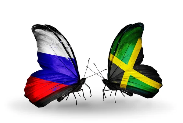 Dwa motyle z flagi Rosji i Jamajka na skrzydłach — Zdjęcie stockowe