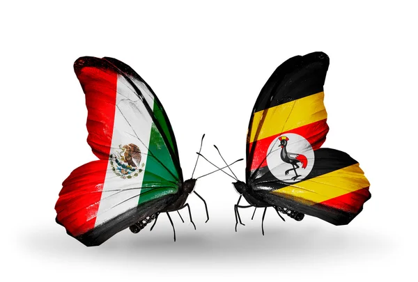 Twee vlinders met vlaggen van mexico en Oeganda op vleugels — Stockfoto