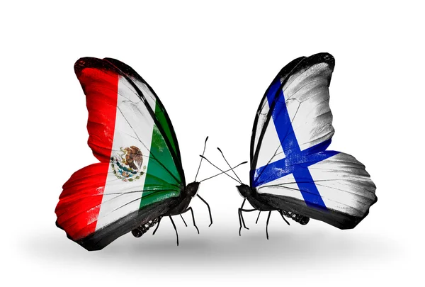 Twee vlinders met vlaggen van mexico en finland op vleugels — Stockfoto