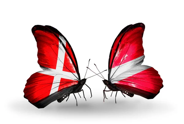 Two butterflies with flags of Denmark and Latvia on wings — Stock Photo, Image
