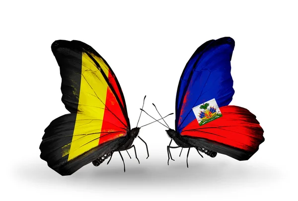 Mariposas con banderas de Bélgica y Haití en alas — Foto de Stock