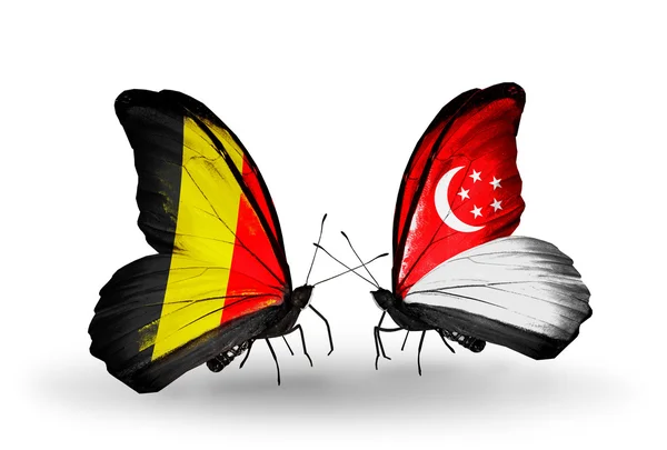 Butterflies with Belgium and Singapore flags on wings — Stock Photo, Image