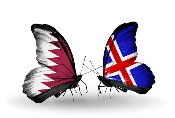 Butterflies with Qatar and Iceland flags on wings — Stock Photo, Image