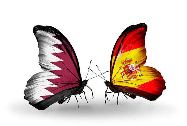 Papillons avec drapeaux Qatar et Espagne sur les ailes — Photo