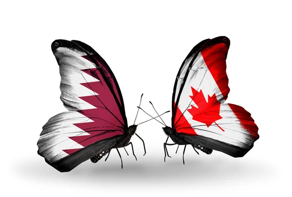 Motyle z katar i Kanada flagi na skrzydłach — Zdjęcie stockowe