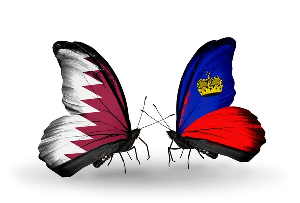 Borboletas com bandeiras do Qatar e Liechtenstein em asas — Fotografia de Stock