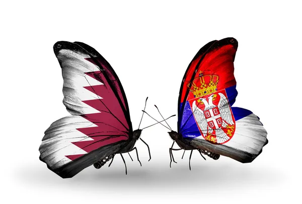 Butterflies with Qatar and Serbia flags on wings — Stock Photo, Image