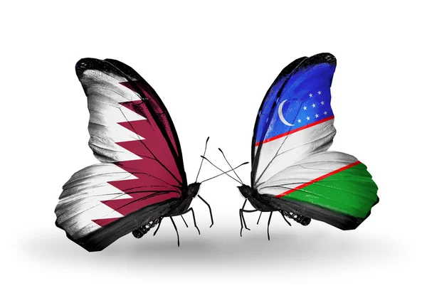 Kelebek kanatları üzerinde Katar ve Özbekistan'a bayraklı — Stok fotoğraf