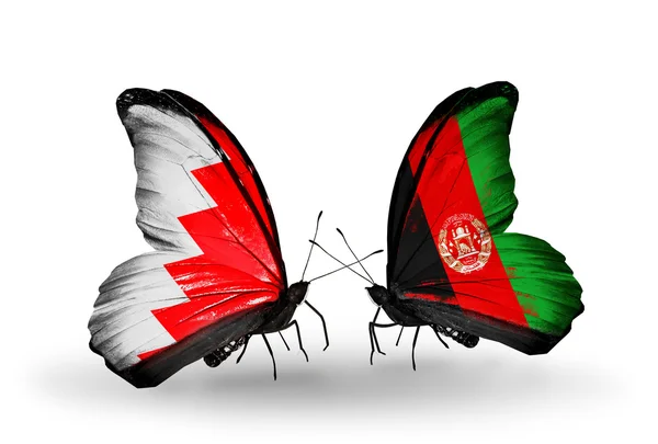 Schmetterlinge mit Bahrain und afghanischen Flaggen auf Flügeln — Stockfoto