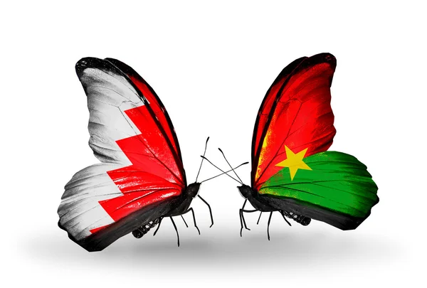 Kelebek kanatları üzerinde Bahreyn ve burkina faso bayraklı — Stok fotoğraf