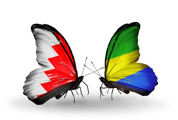 Kelebek kanatları üzerinde Bahreyn ve gabon bayraklı — Stok fotoğraf