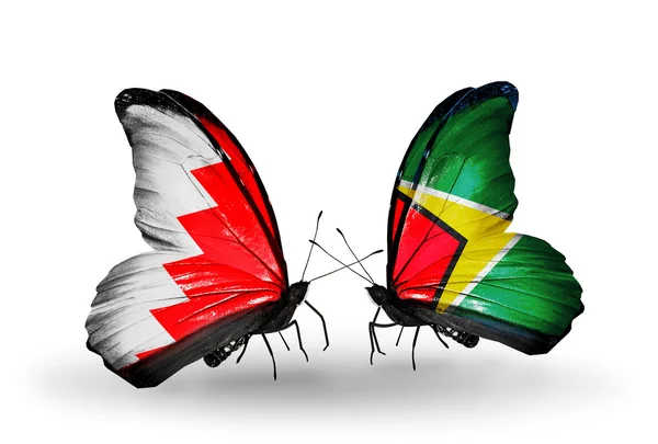 Farfalle con bandiere Bahrain e Guyana sulle ali — Foto Stock