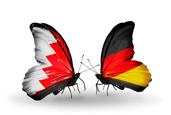 Butterflies with Bahrain and Germany flags on wings — Stock Photo, Image