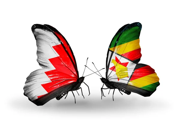 Motyle z flagi Bahrajnu i zimbabwe na skrzydłach — Zdjęcie stockowe