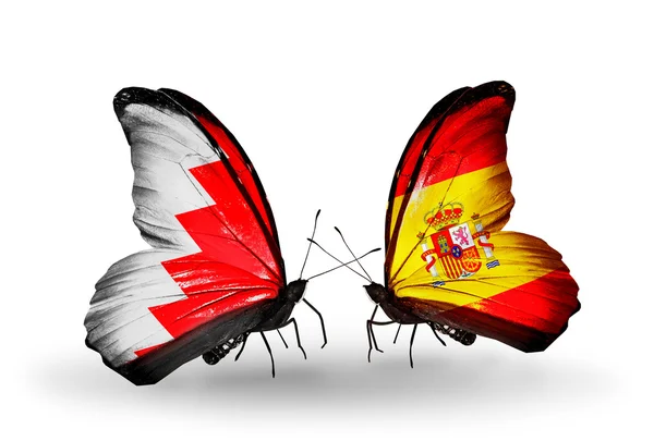 Borboletas com bandeiras do Bahrein e Espanha em asas — Fotografia de Stock