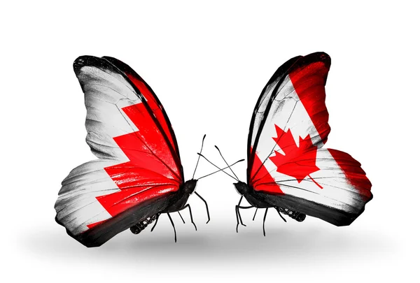 Farfalle con bandiere Bahrain e Canada sulle ali — Foto Stock