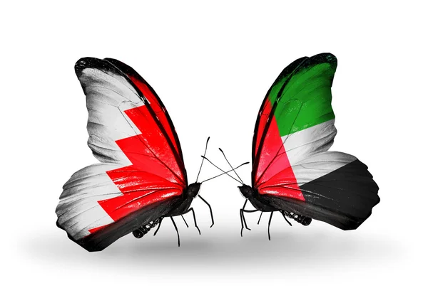 Fjärilar med bahrain och uae flaggor på vingar — Stockfoto