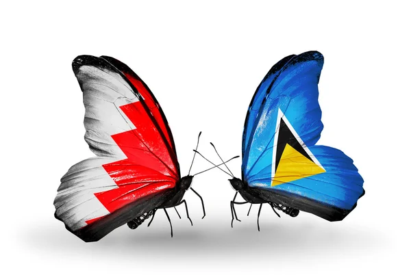 Butterflies with Bahrain and Saint Lucia flags on wings — Stock Photo, Image