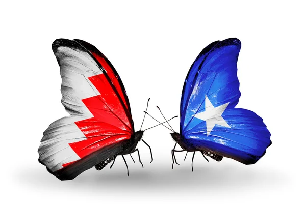 Mariposas con banderas de Bahréin y Somalia en alas — Foto de Stock