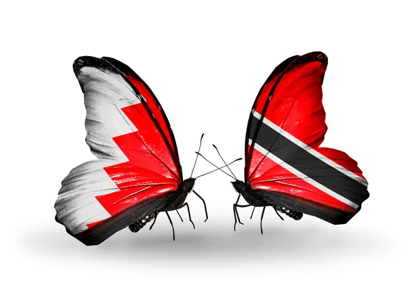 Papillons avec des drapeaux Bahreïn et Tobago sur les ailes — Photo